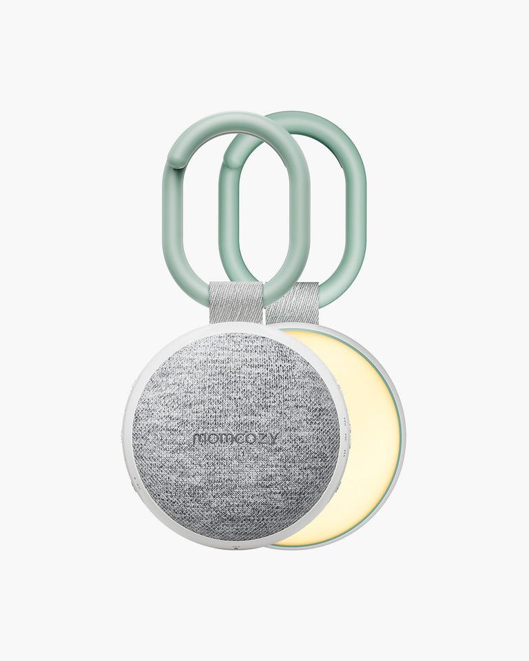Translation missing: en.Momcozy Portable Sound Machine featuring a light gray speaker, white frame, green handle and adjustable light function